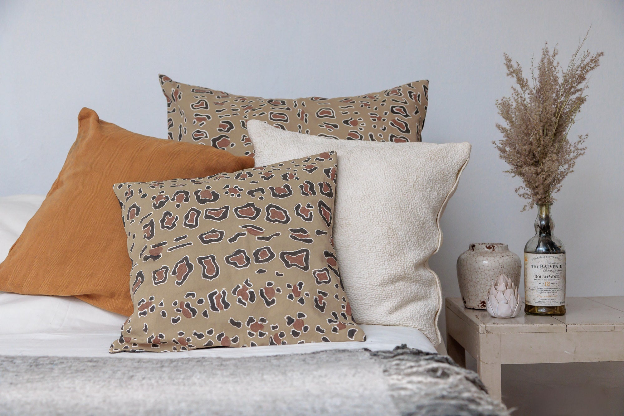 Artisan-crafted cushion cover with intricate leopard batik motif, ideal for adding a safari-inspired flair to your decor.