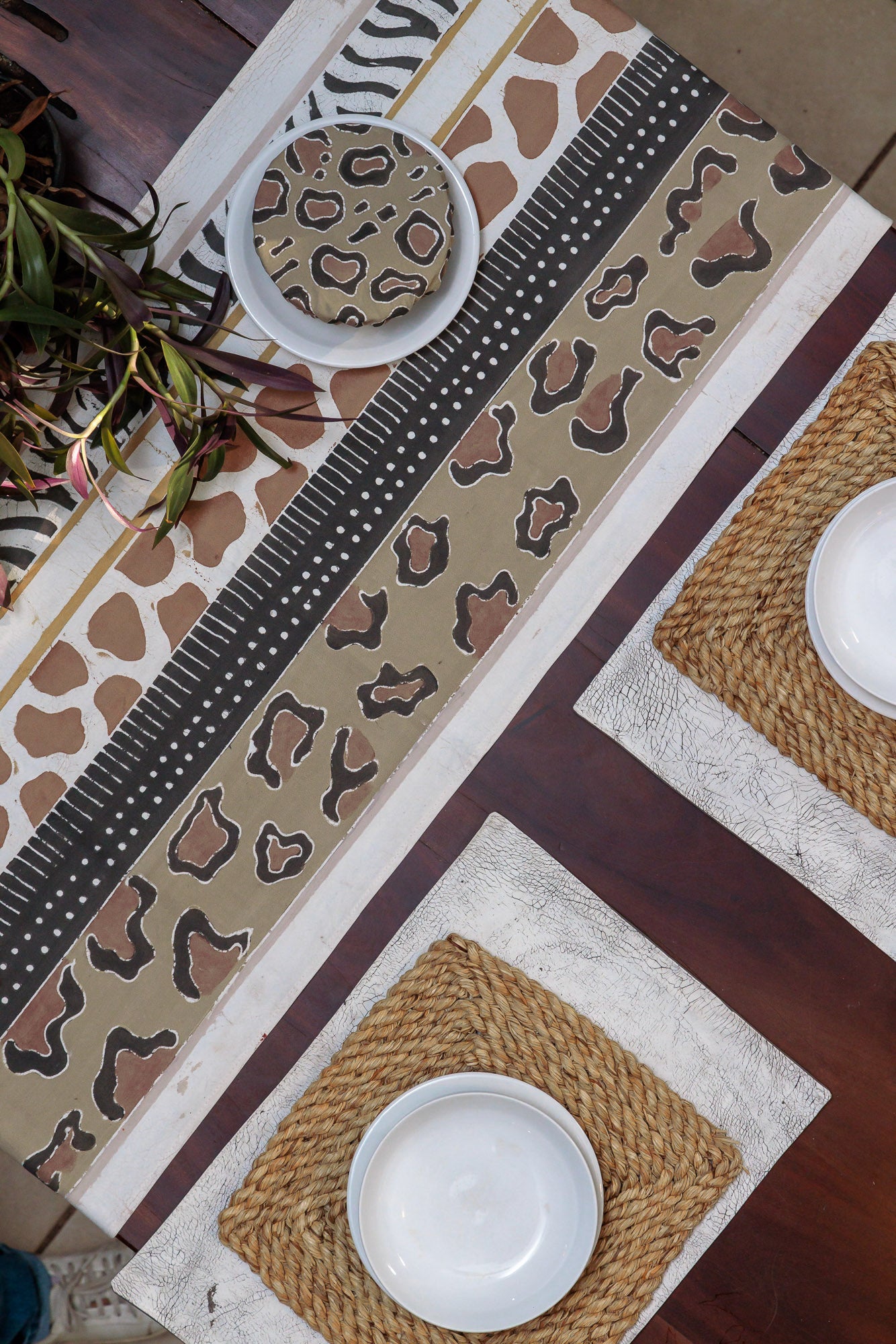 The perfect African handmade table runner adorned with intricate safari patterns, like leopard and zebra prints.