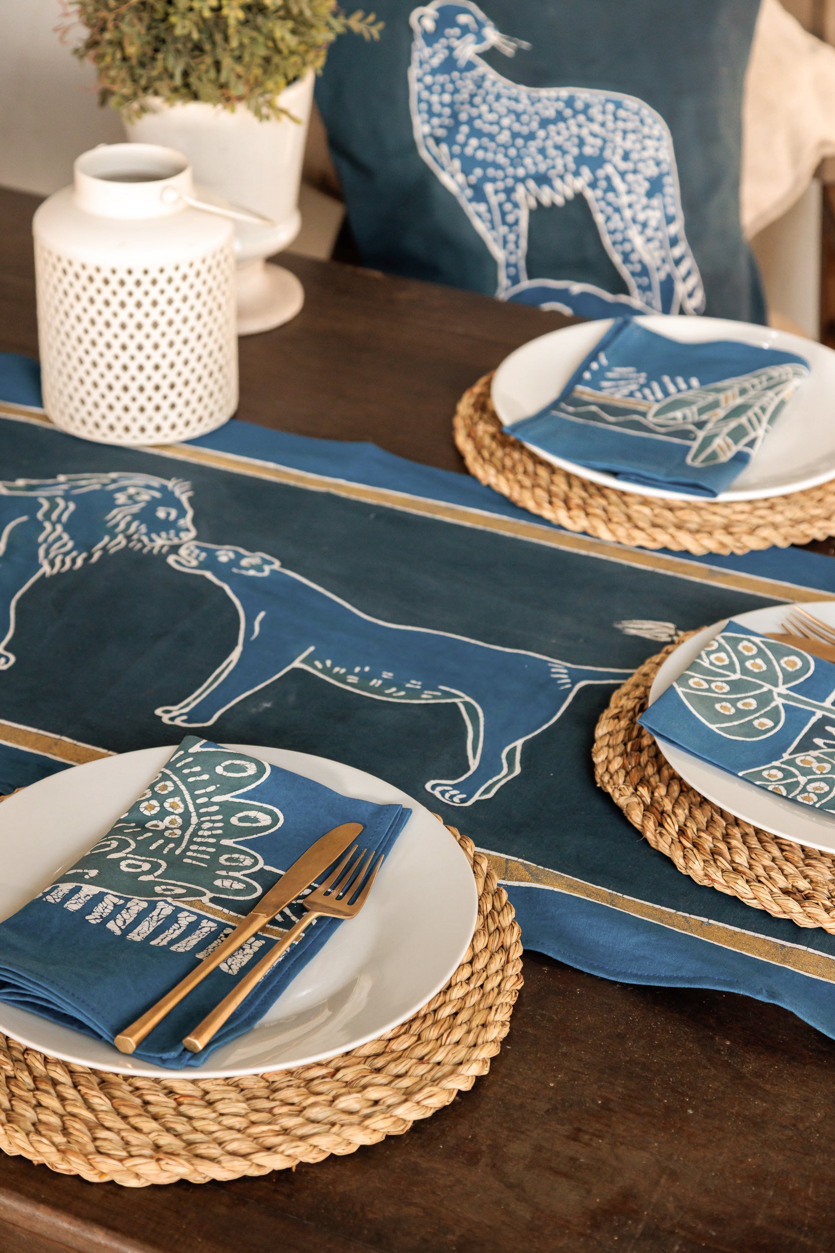 Table setting with blue table runner, featuring lions in a blue colourway.