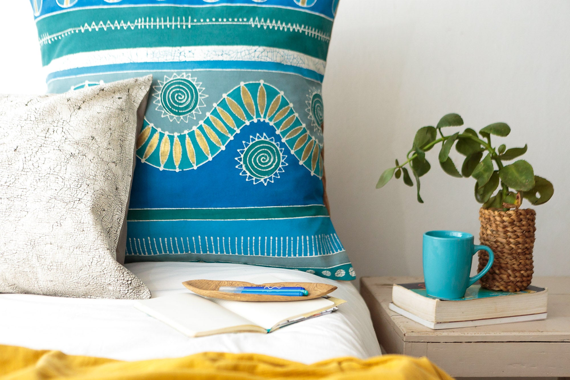 a virbant blue and tea cushion oover with gold accents