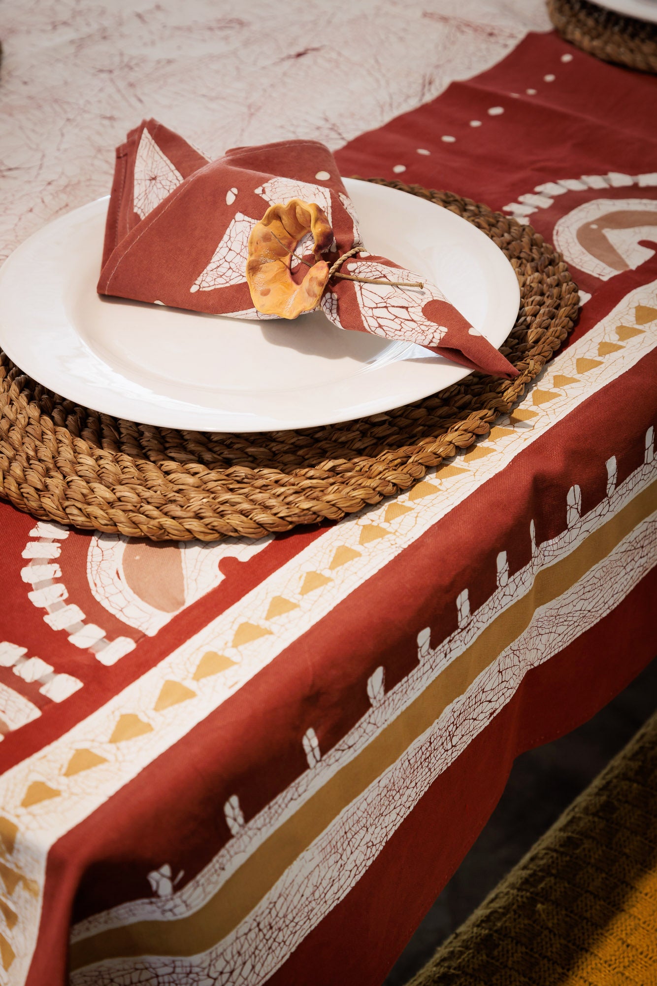 Handcrafted red napkin set with batik pattern, adding artistic elegance to your table setting.