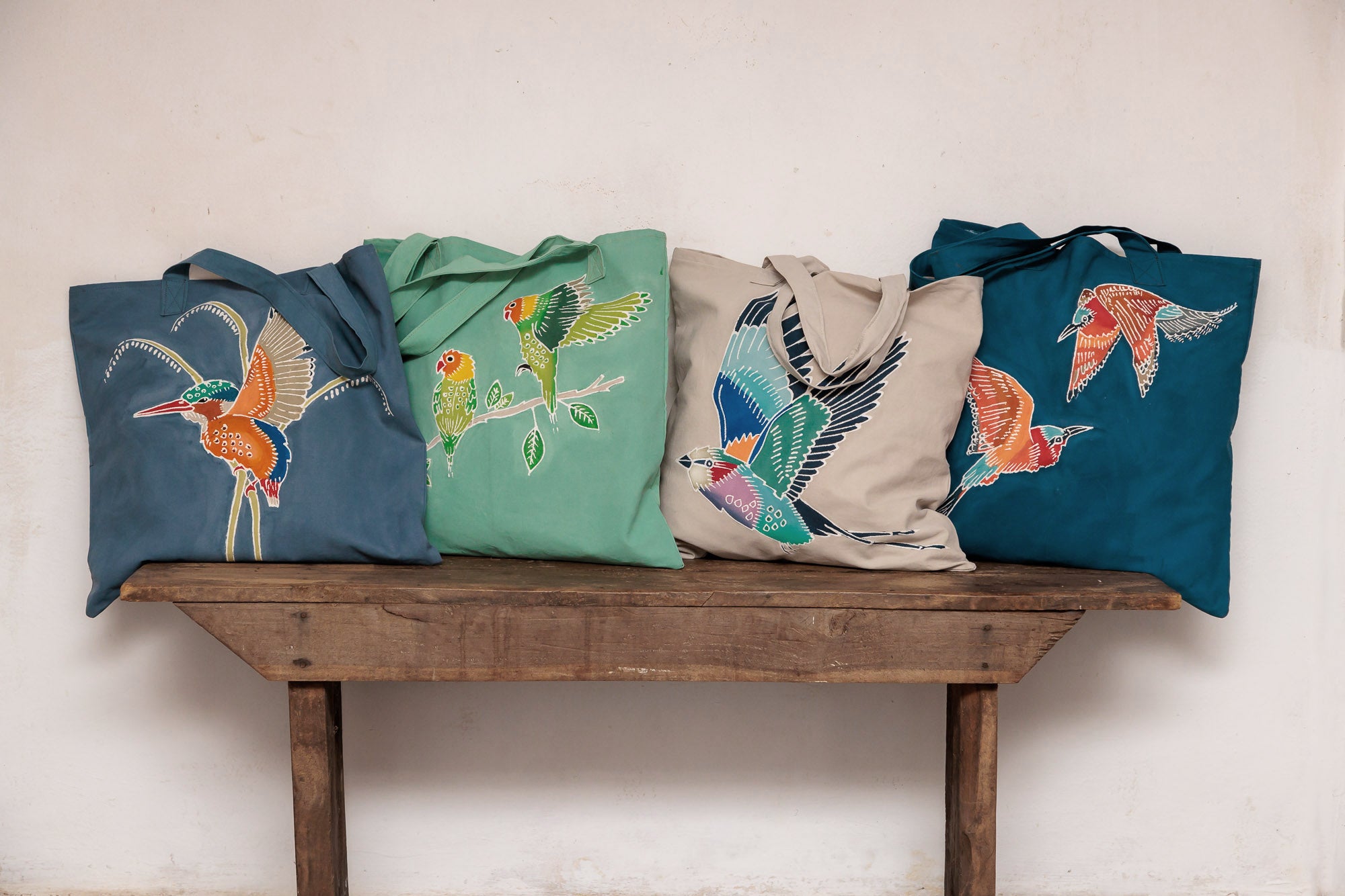 African made and handpainted blue tote bag adorned with colourful birds.