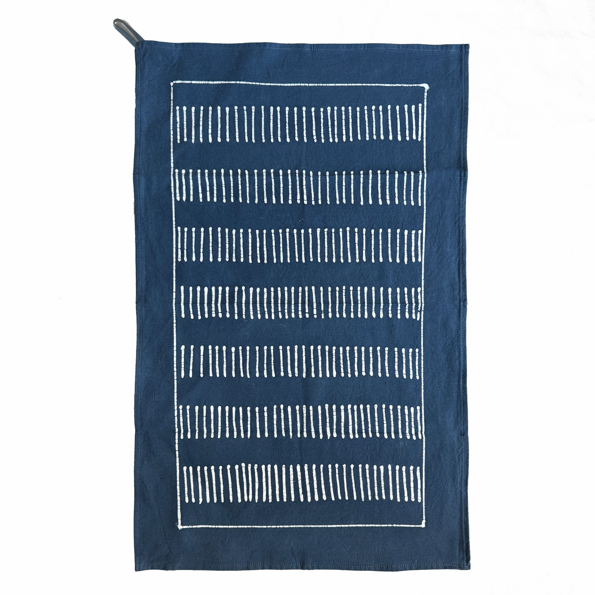 Navy blue tea towel with white geometric pattern on a white background