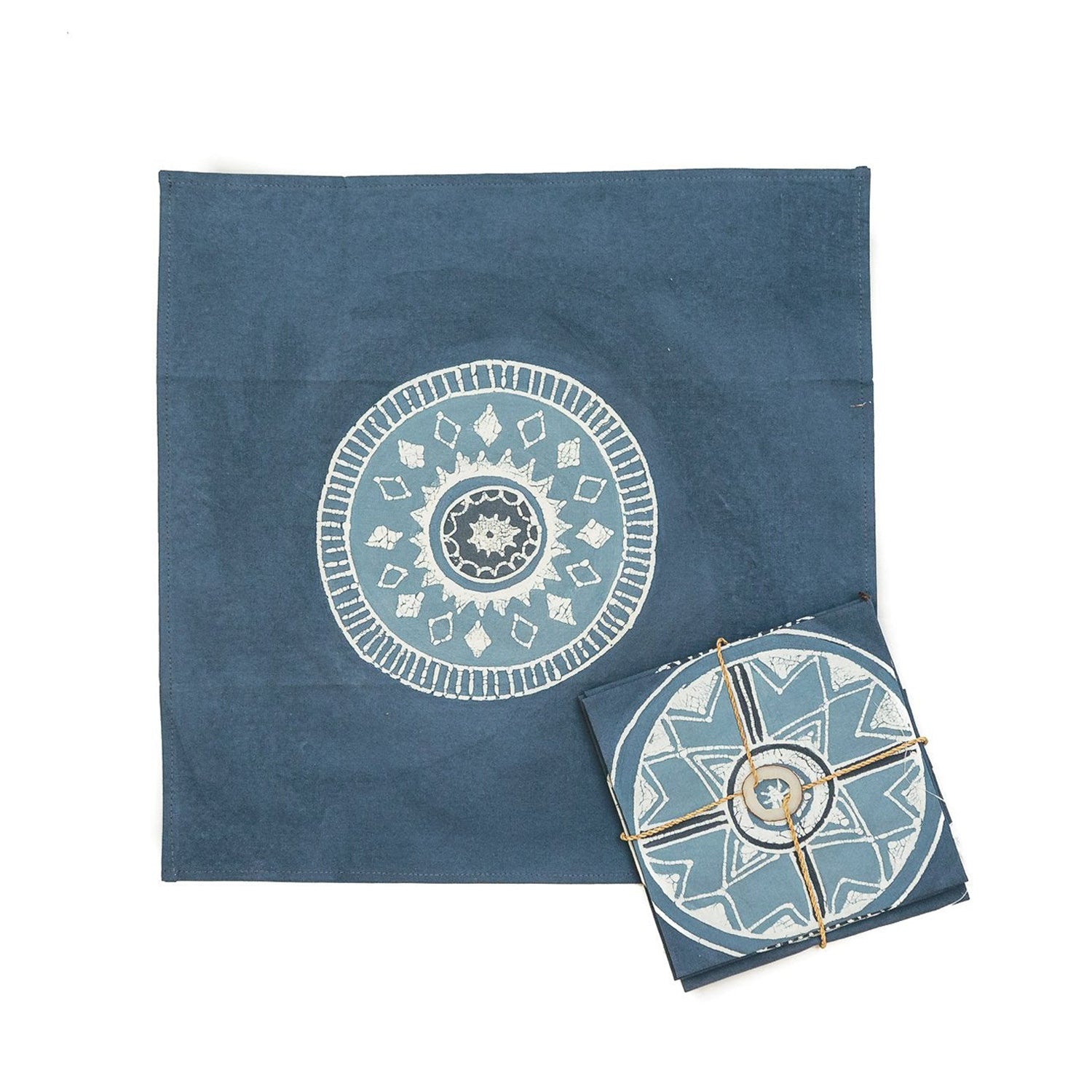 The perfect indigo napkins adorned with detailed circular patterns and gold accents on 100% cotton.