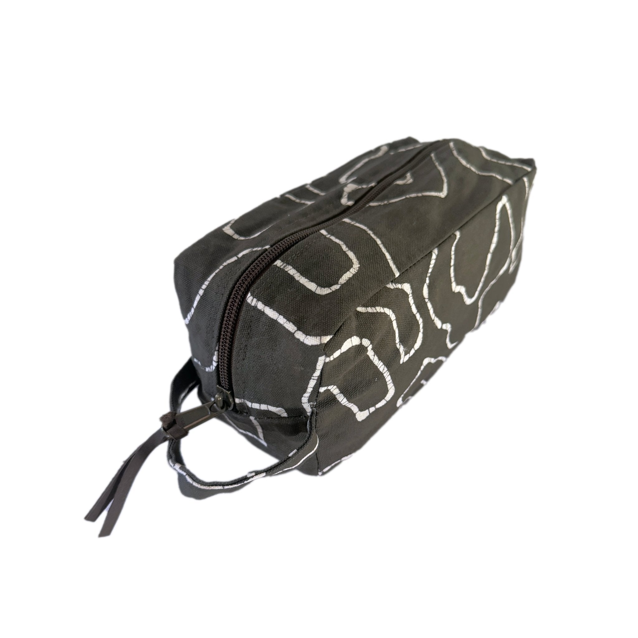 The perfect balance of sustainable elegance with our charcoal travel pouch decorated in detailed squiggles.