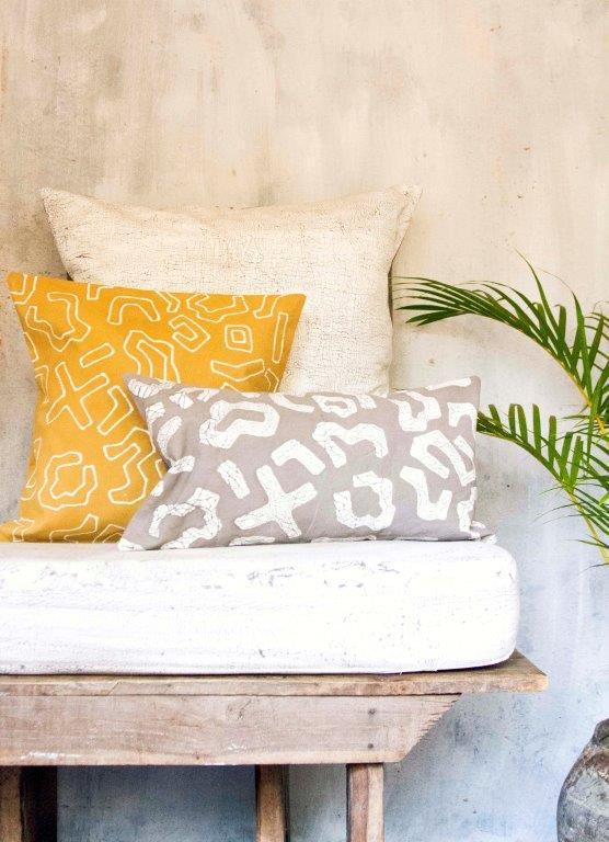 Artisan-crafted accent pillow cover in bright yellow, showcasing a dynamic graphic batik pattern for a vibrant home.