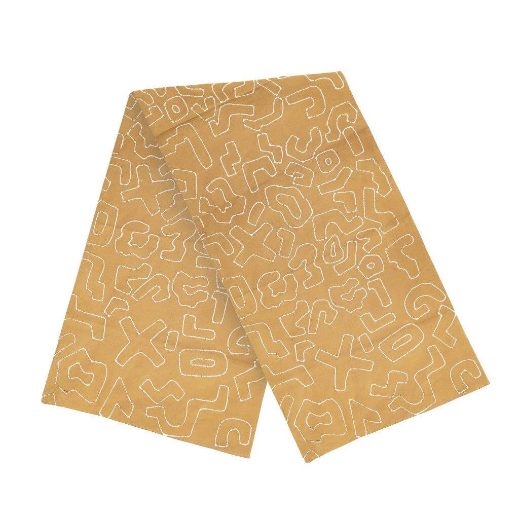 The perfect mustard yellow table runner adorned with a beautiful African inspired squiggle pattern.