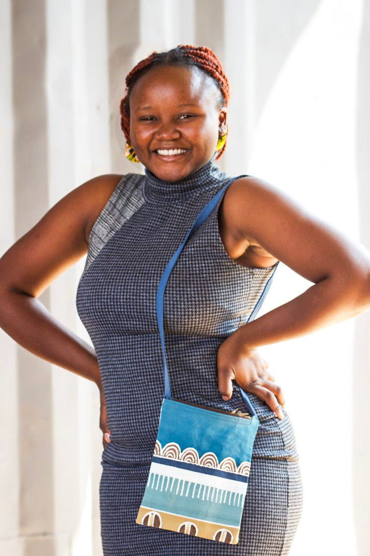 Azure blue cross body small zip up passport bag.