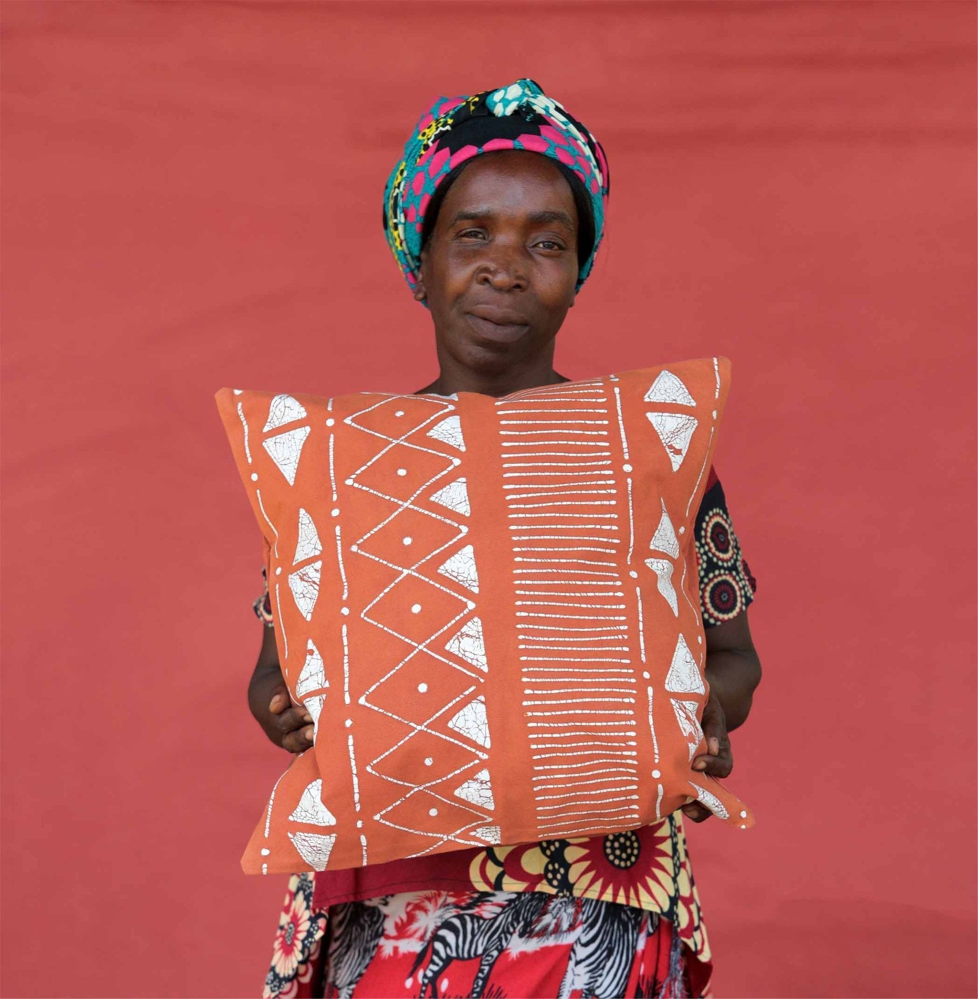 Linear patterned deep red cushion covers, to brighten and bolden your living room with African made products.