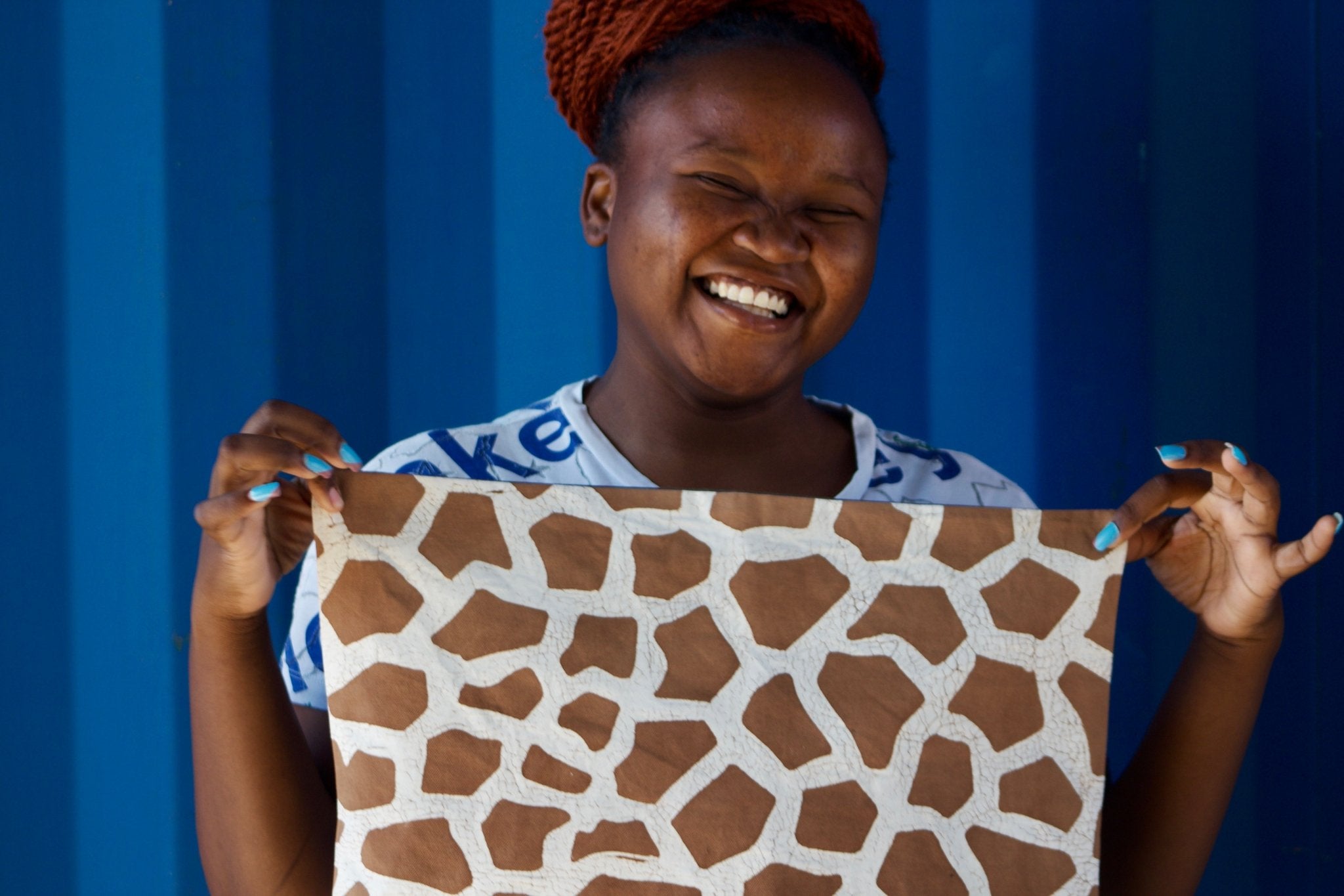 Eco-conscious pillow cover featuring a giraffe pattern in batik, blending natural aesthetics with sustainable design.