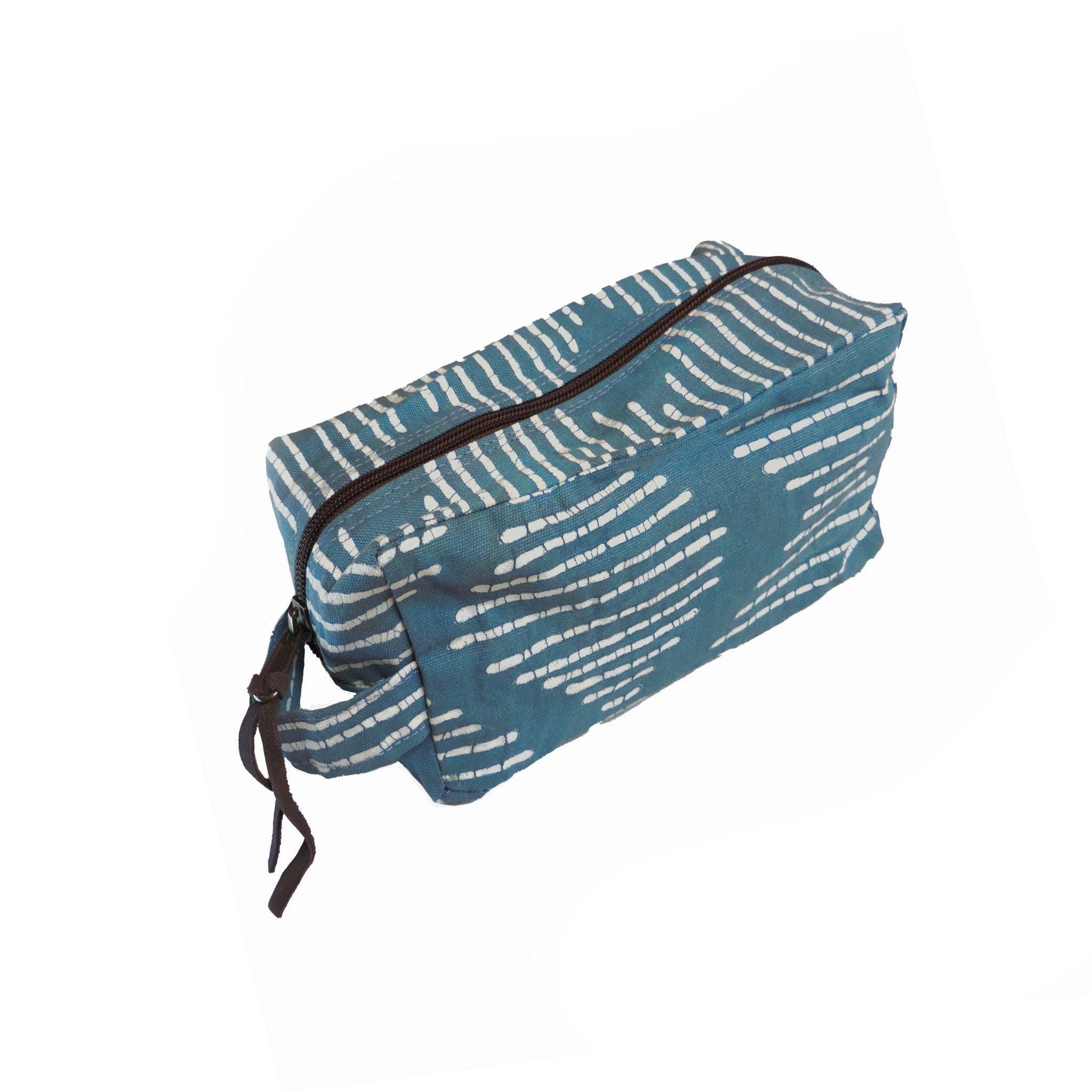 The perfect indigo travel pouch adorned with an African inspired wave pattern and made from 100% cotton.