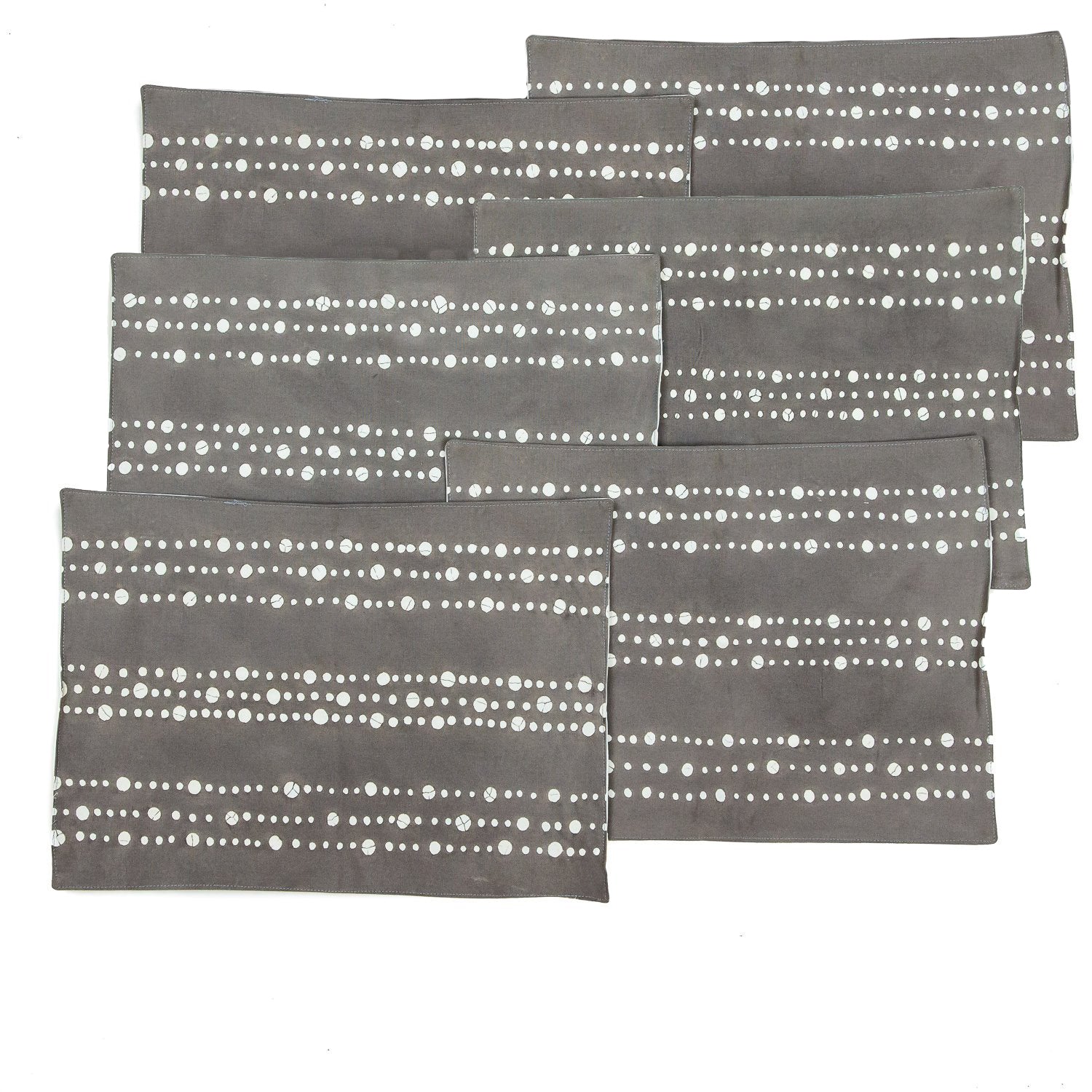 Hand-spotted charcoal table mats, adding a unique artisanal touch to your dining experience.
