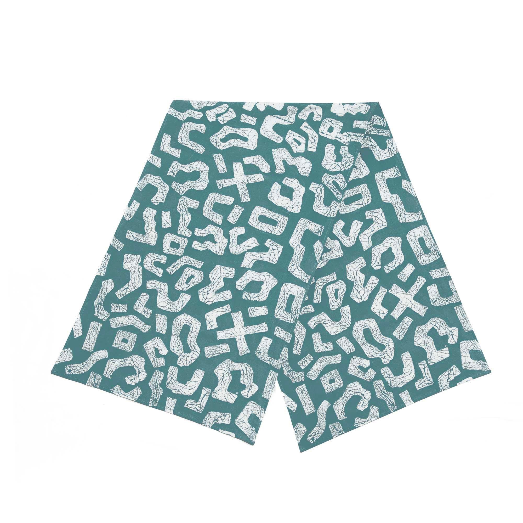 a teal coloured table runner sustainably made with bold geometric patterns made in batik