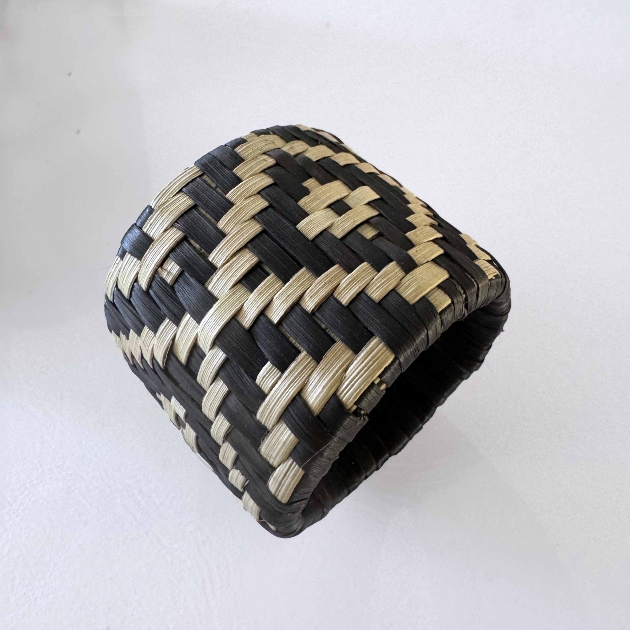 Black and white palm woven napkin ring holder.