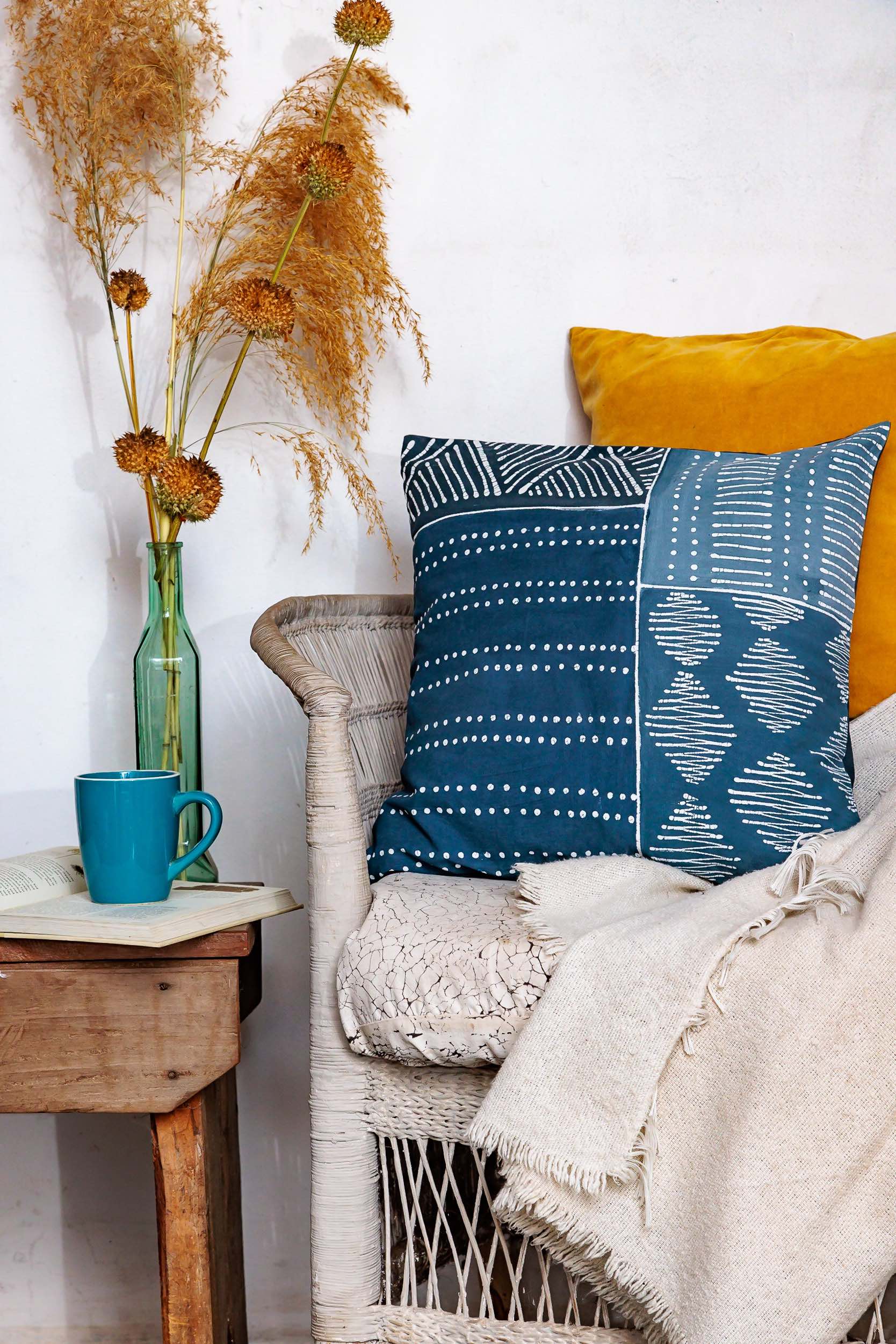 Eco-friendly cushion cover made from cotton, featuring indigo patchwork and tribal designs in dark blues.