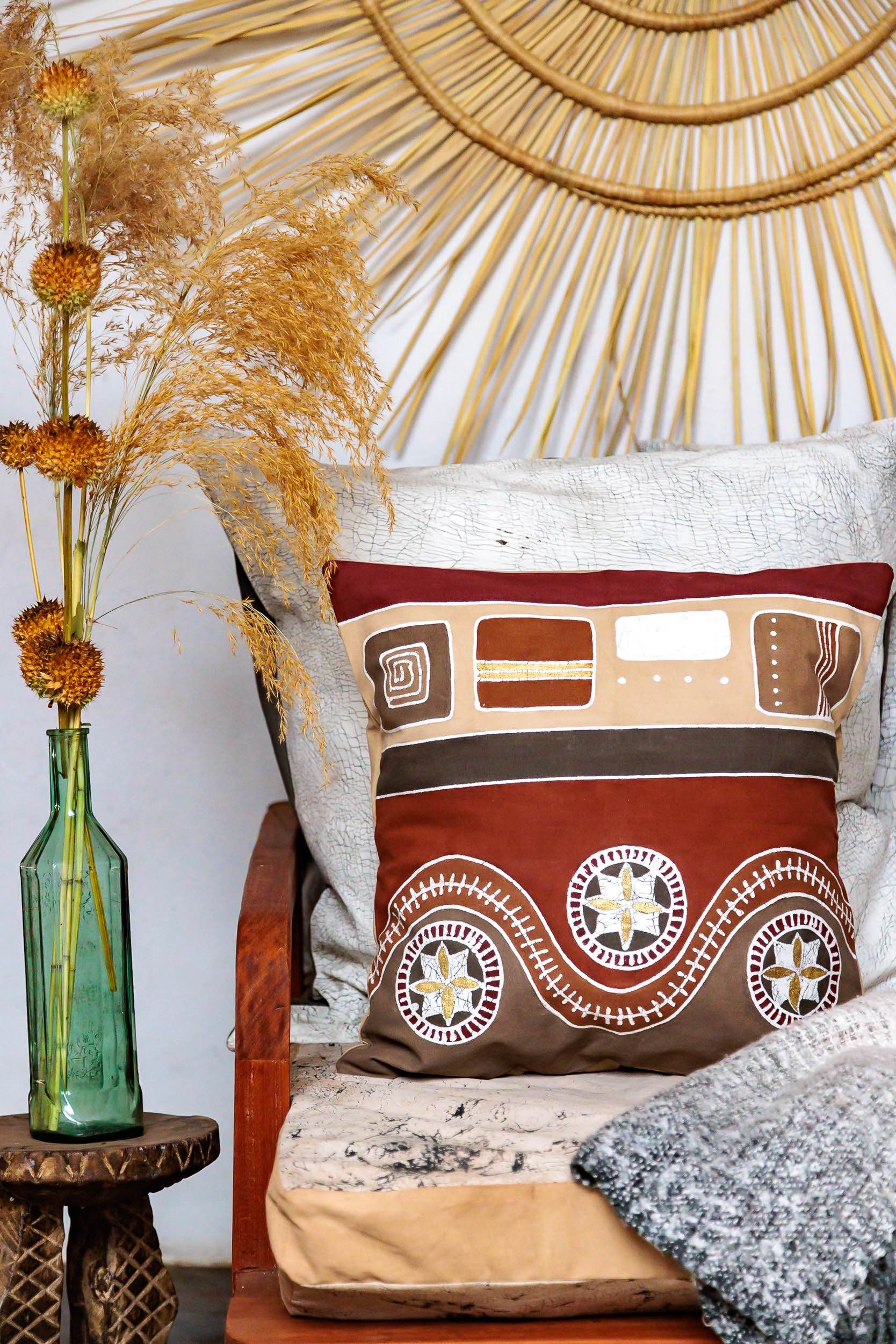 Eco-friendly pillow cover with warm Mali tribal pattern in red tones.