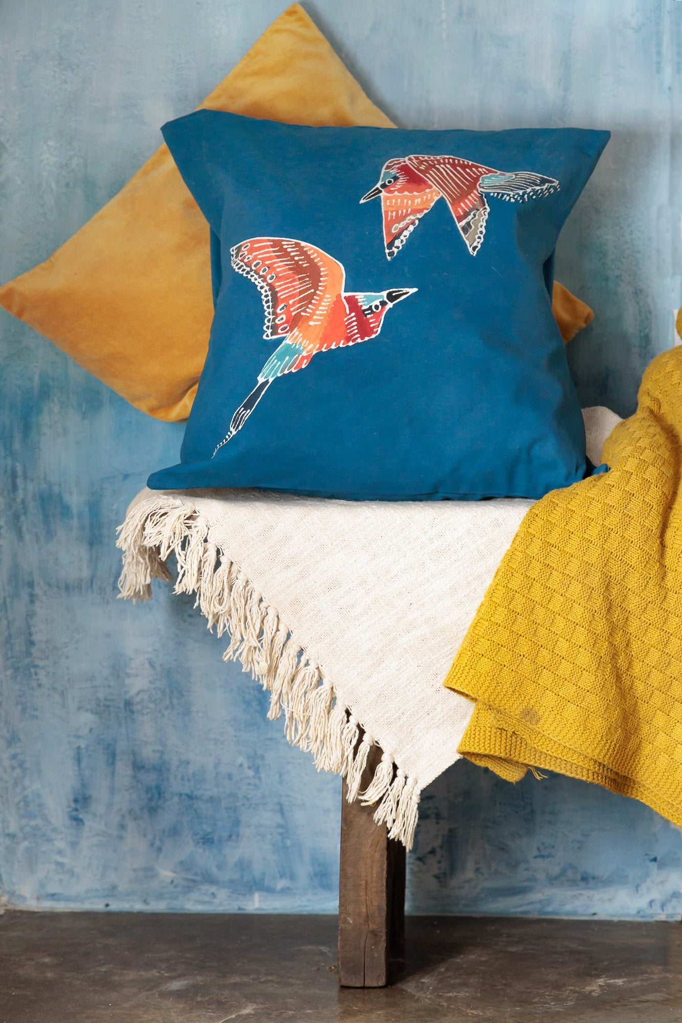 Hand-painted bird cushion covers with deep blue backgrounds perfect for the eco-conscious homes.