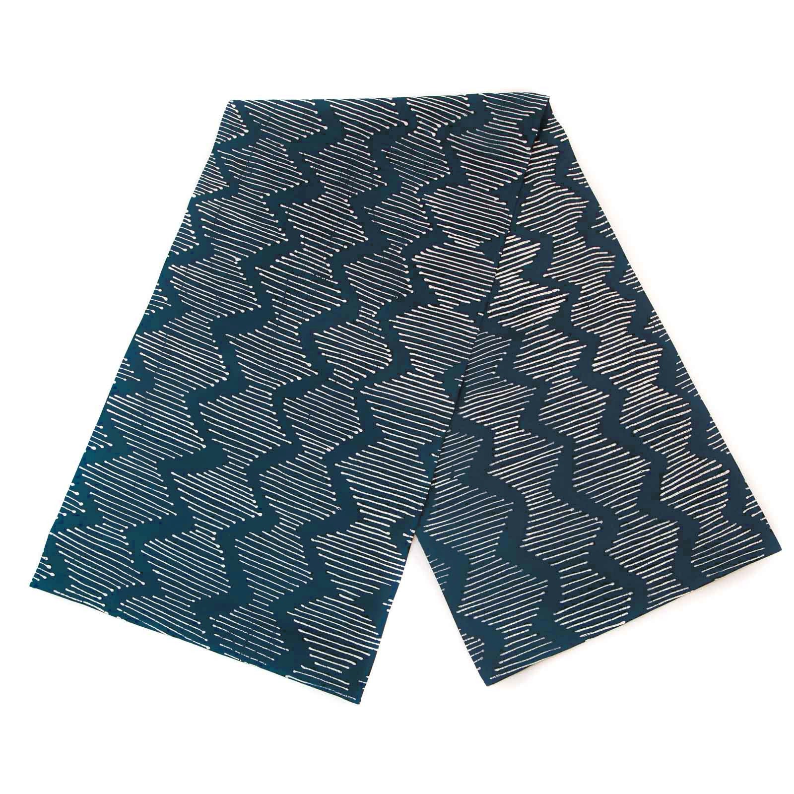 Indigo table runner adorned with interesting wave pattern and made in Africa.