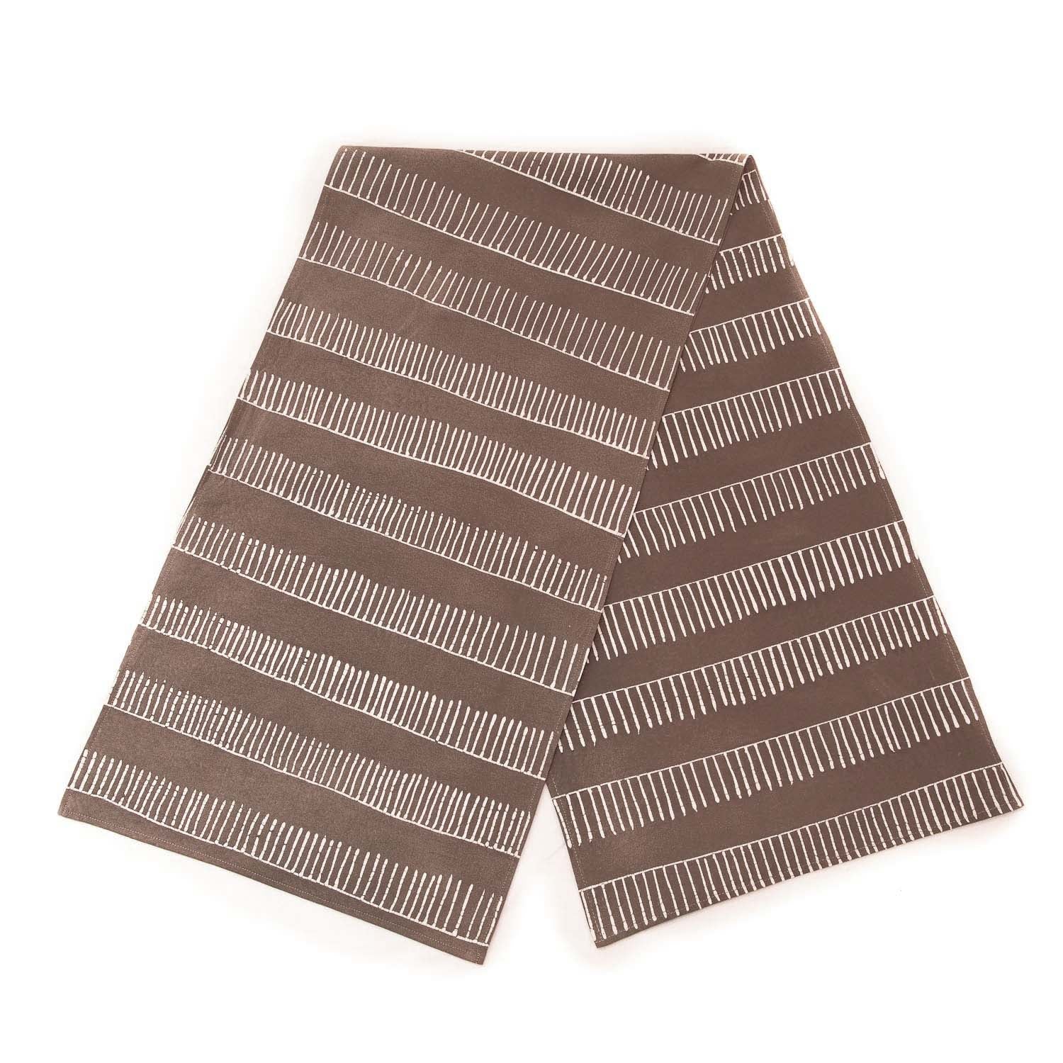The perfect dark taupe table runner made from 100% cotton with a linear pattern.