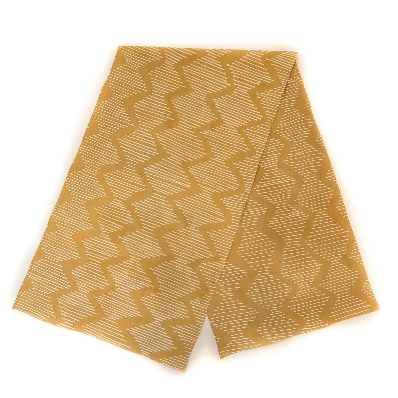 The perfect mustard yellow table runner made with interesting wave patterns using a traditional Batik technique.