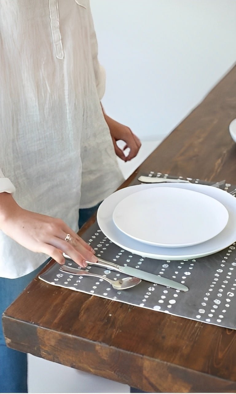 Eco-friendly place mats in charcoal with hand-spotted design, perfect for sustainable dining settings.