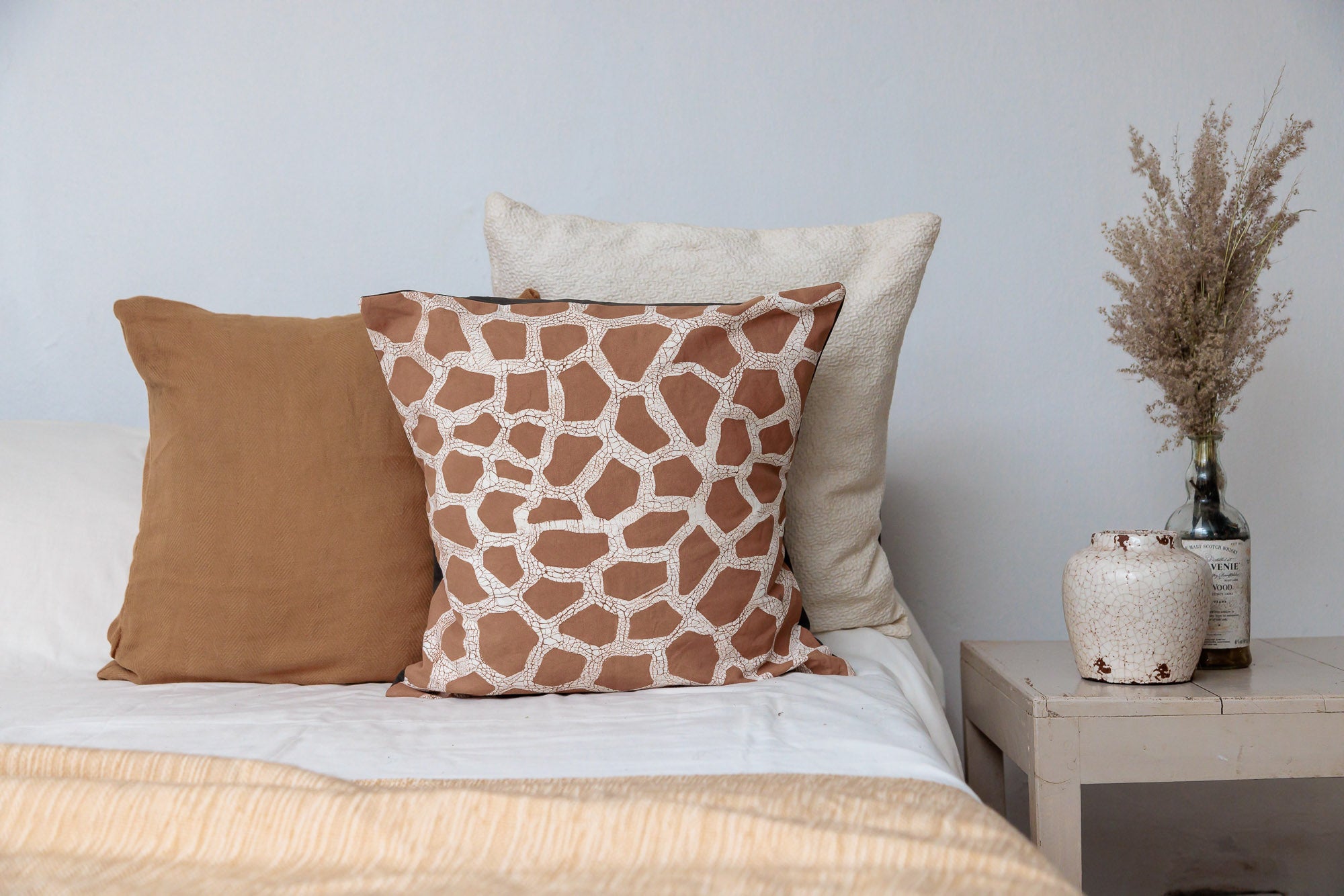 Giraffe pattern batik pillow cover, handmade with organic materials for a unique and cultural touch.