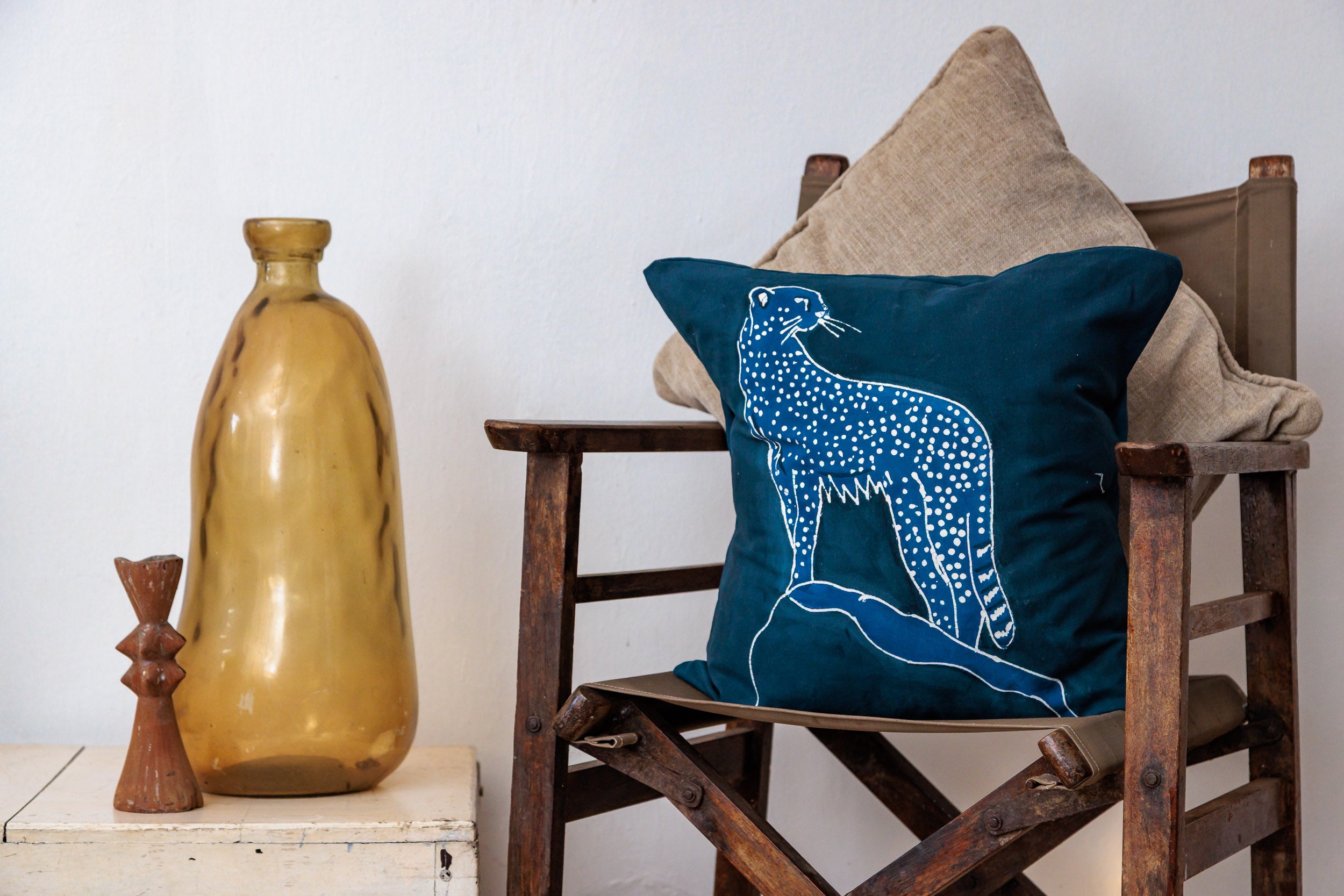 Navy blue pillow with a cheetah design, handcrafted batik from Africa supporting conservation.