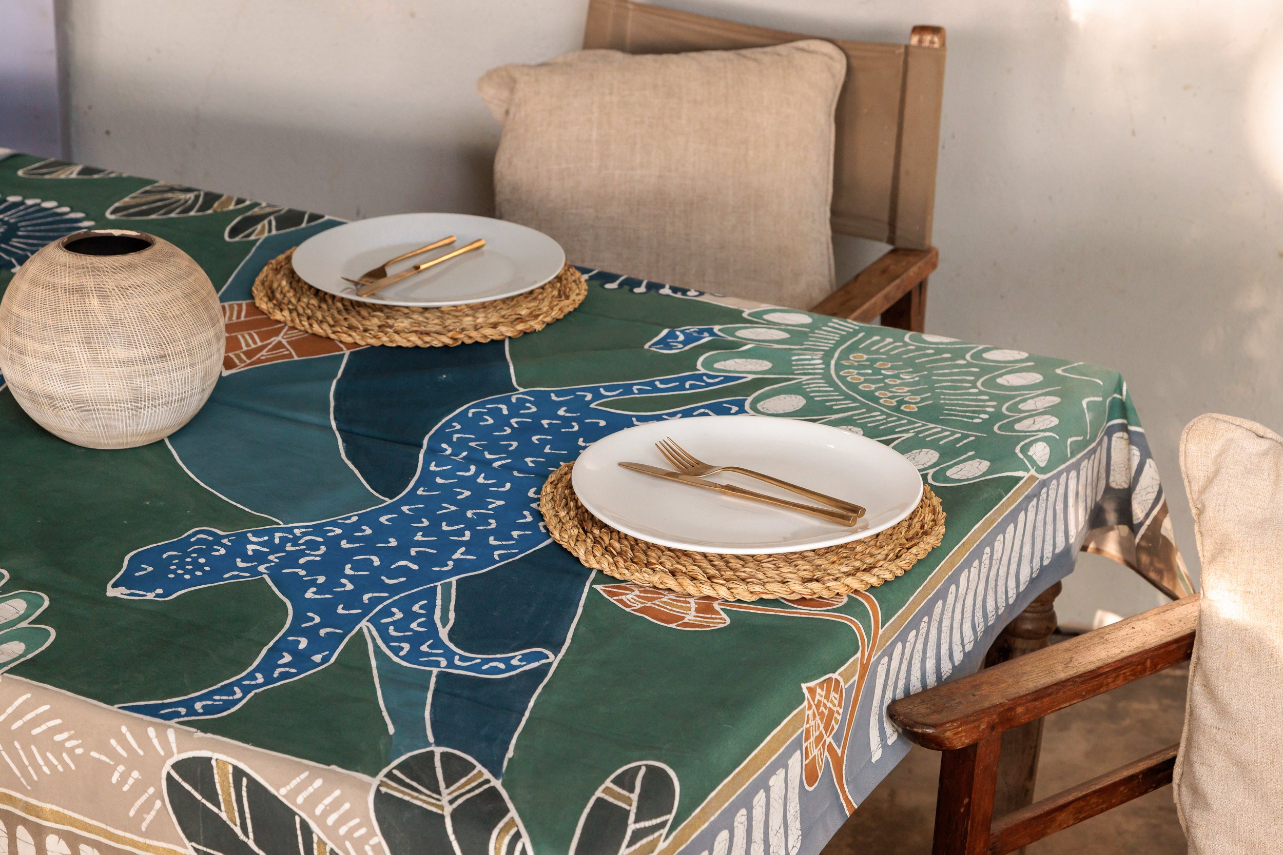Table setting with a decorative tablecloth featuring leopards, supporting conservation effort in africa