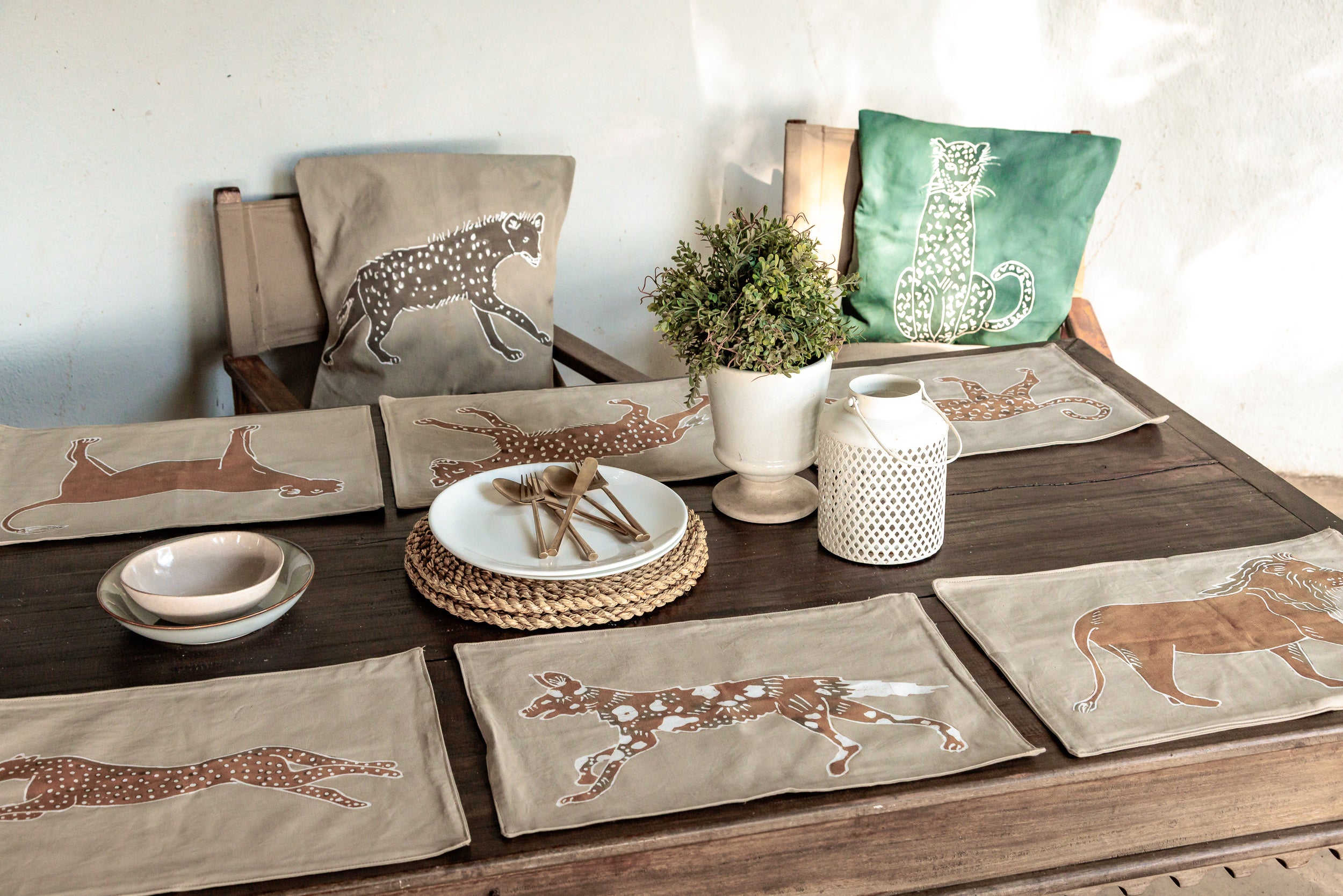 Table setting with beige khaki placemats, featuring wild safari animals that supports conservation efforts.