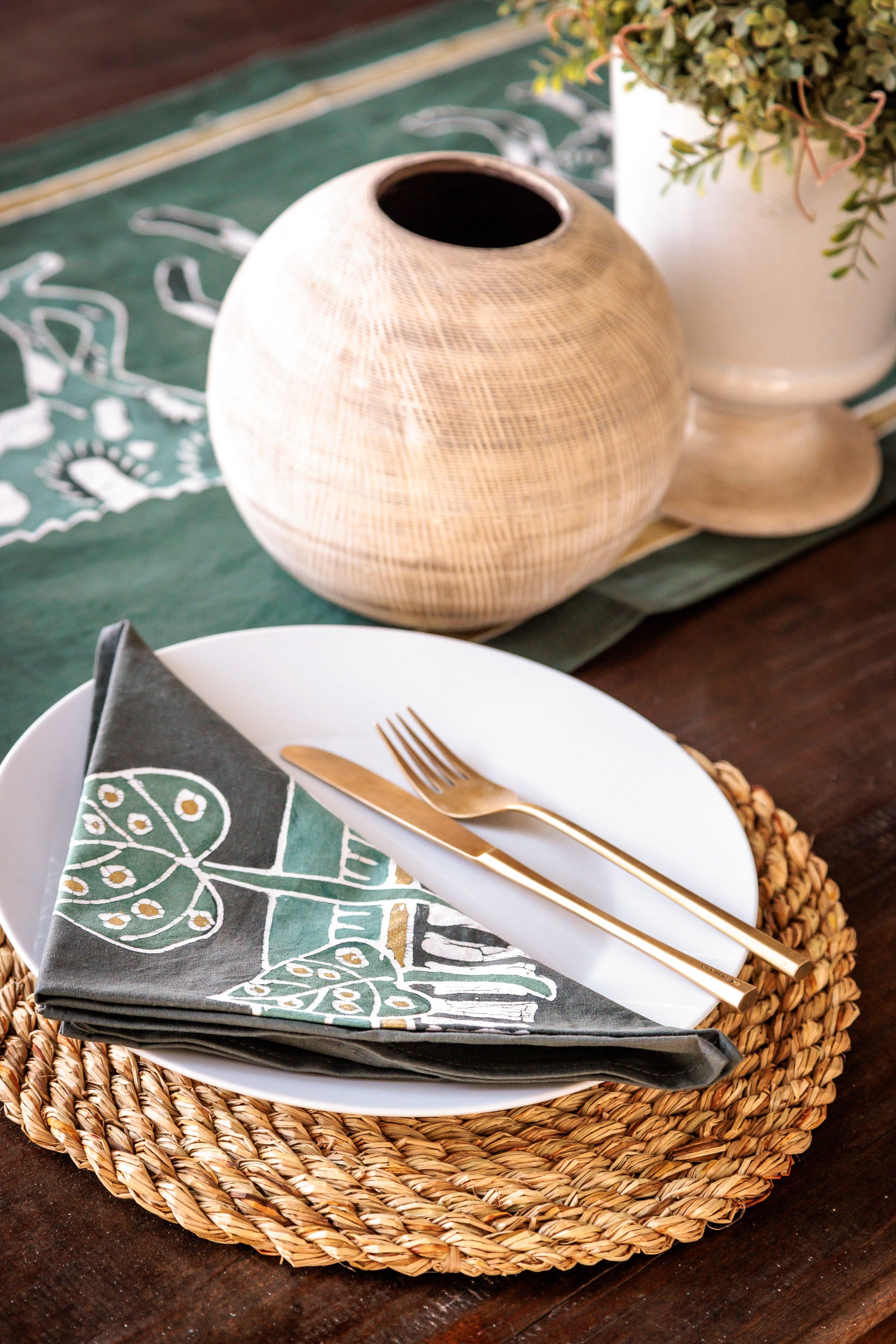 Dining table setting featuring Zambian flower design napkins