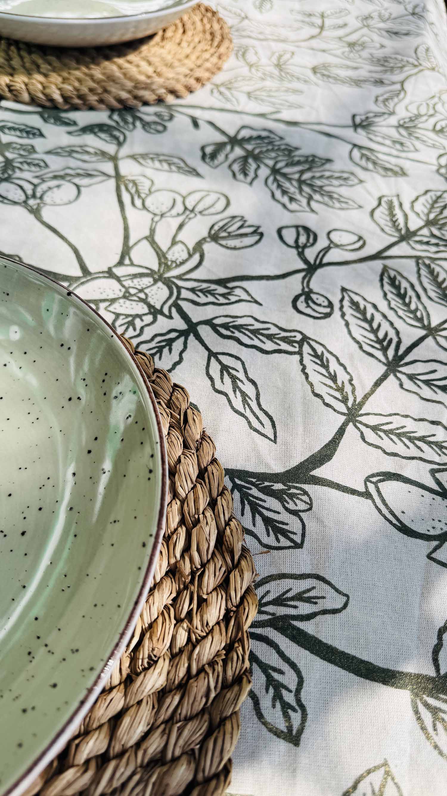 Beige cotton table runner with hand-printed green leaf design, ethically handmade in Zambia—perfect for sustainable kitchens and eco-friendly interior styling.