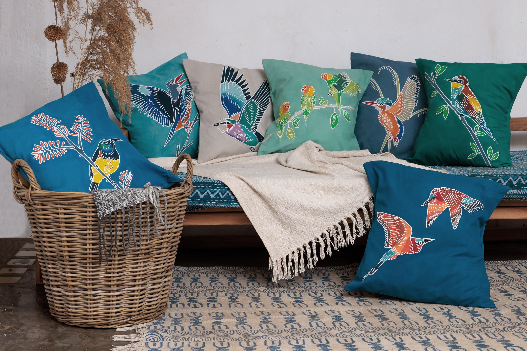 Buy sustainable deep blue handpainted bird cushions to brighten your home and add a touch of African handmade goods.