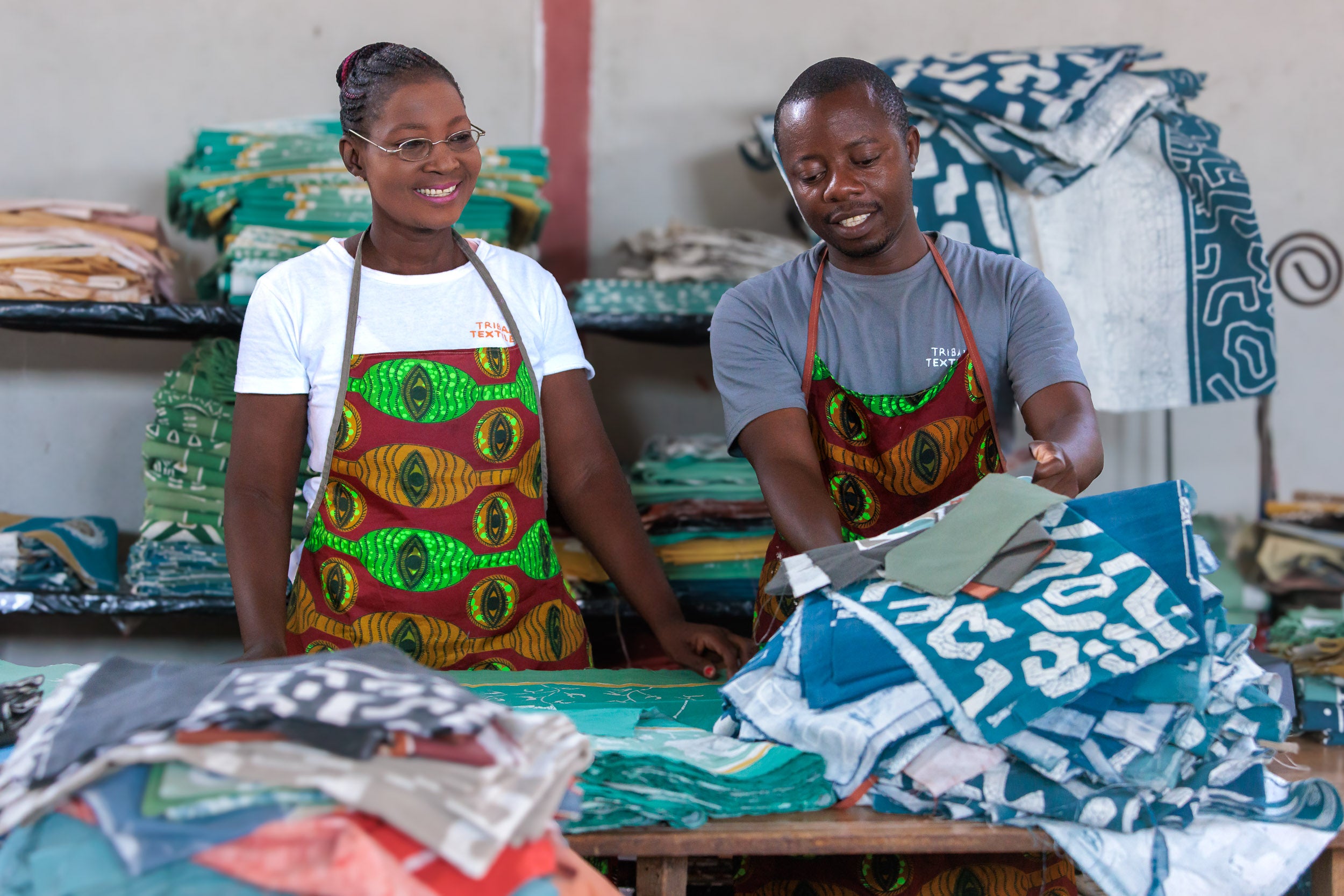 Two people working with fabric in a workshop setting