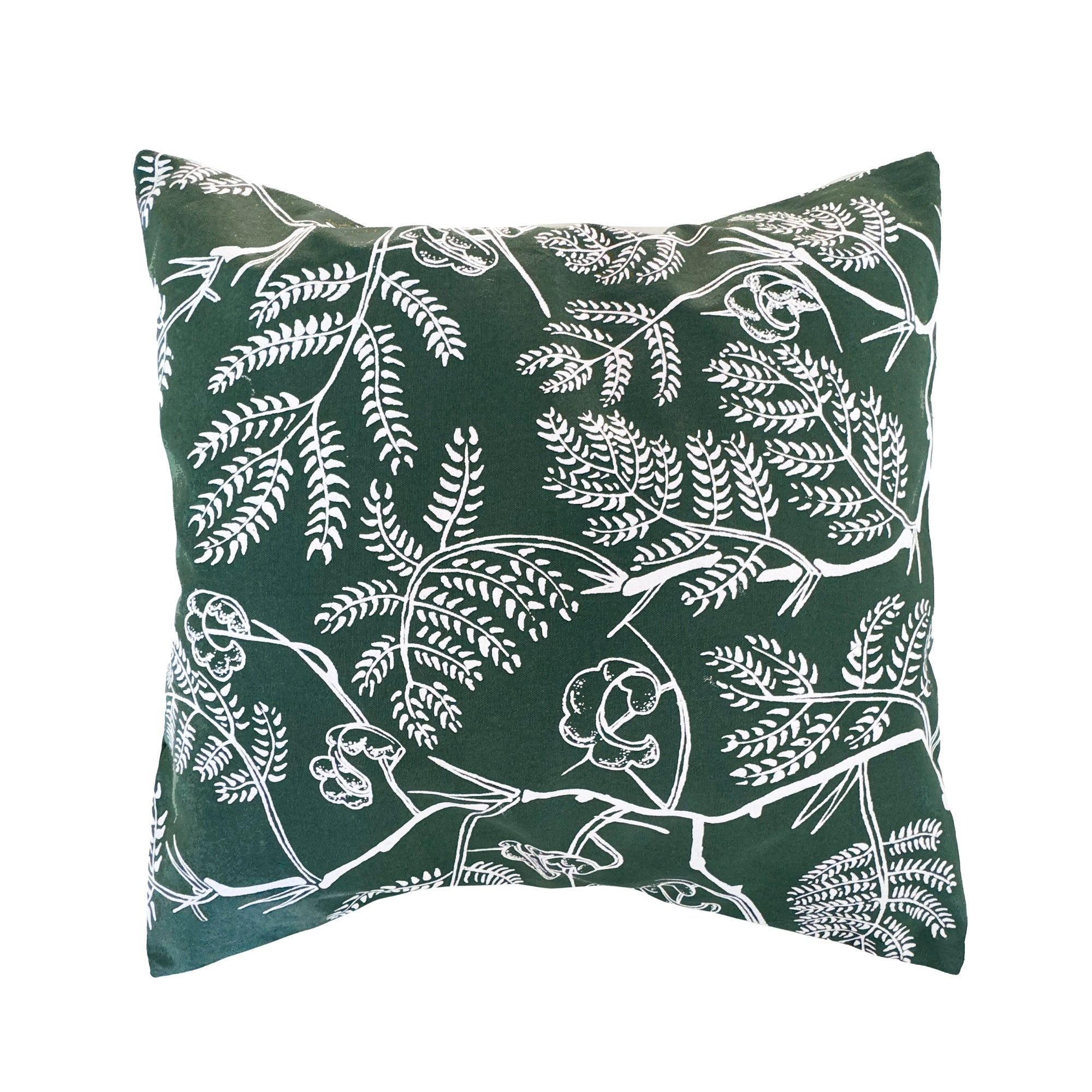 Green cotton cushion cover featuring a hand-printed Winter Thorn floral design, styled on a neutral surface, ethically handcrafted in Zambia for sustainable, eco-friendly living room or bedroom decor and artisan interiors.
