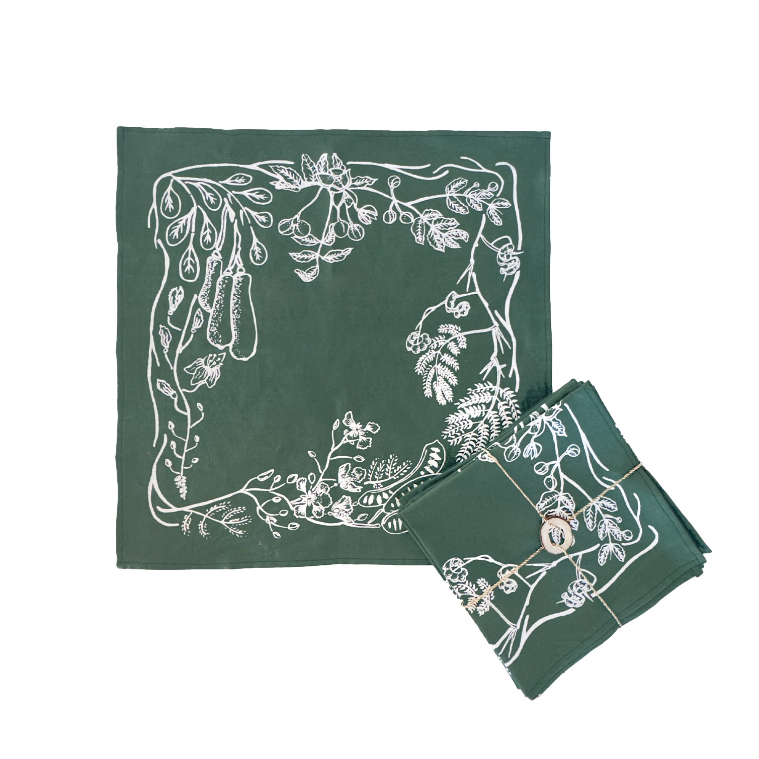 A set of dark green cotton napkins with a leaf border