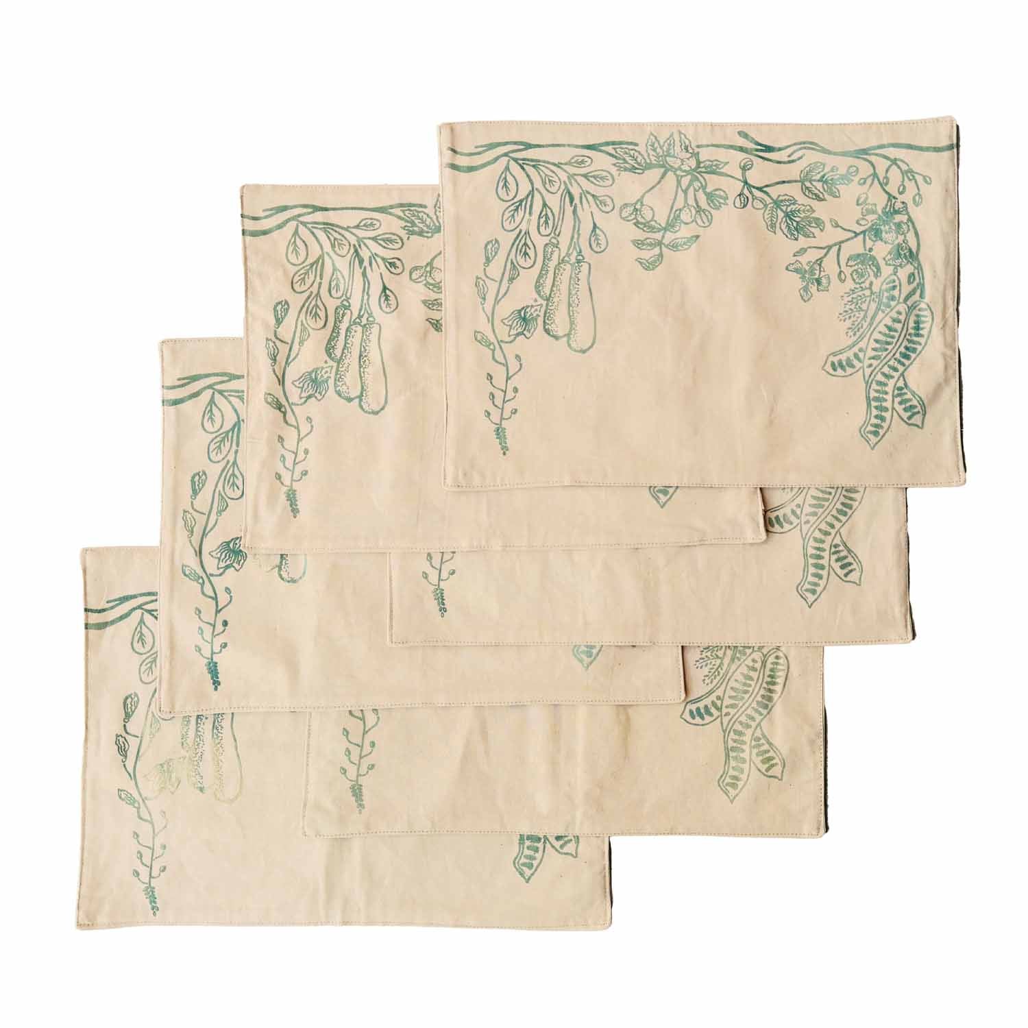 Set of beige cotton table mats with subtle green leaf patterns, ethically handcrafted in Zambia for sustainable, eco-friendly dining room decor and artisan interiors.
