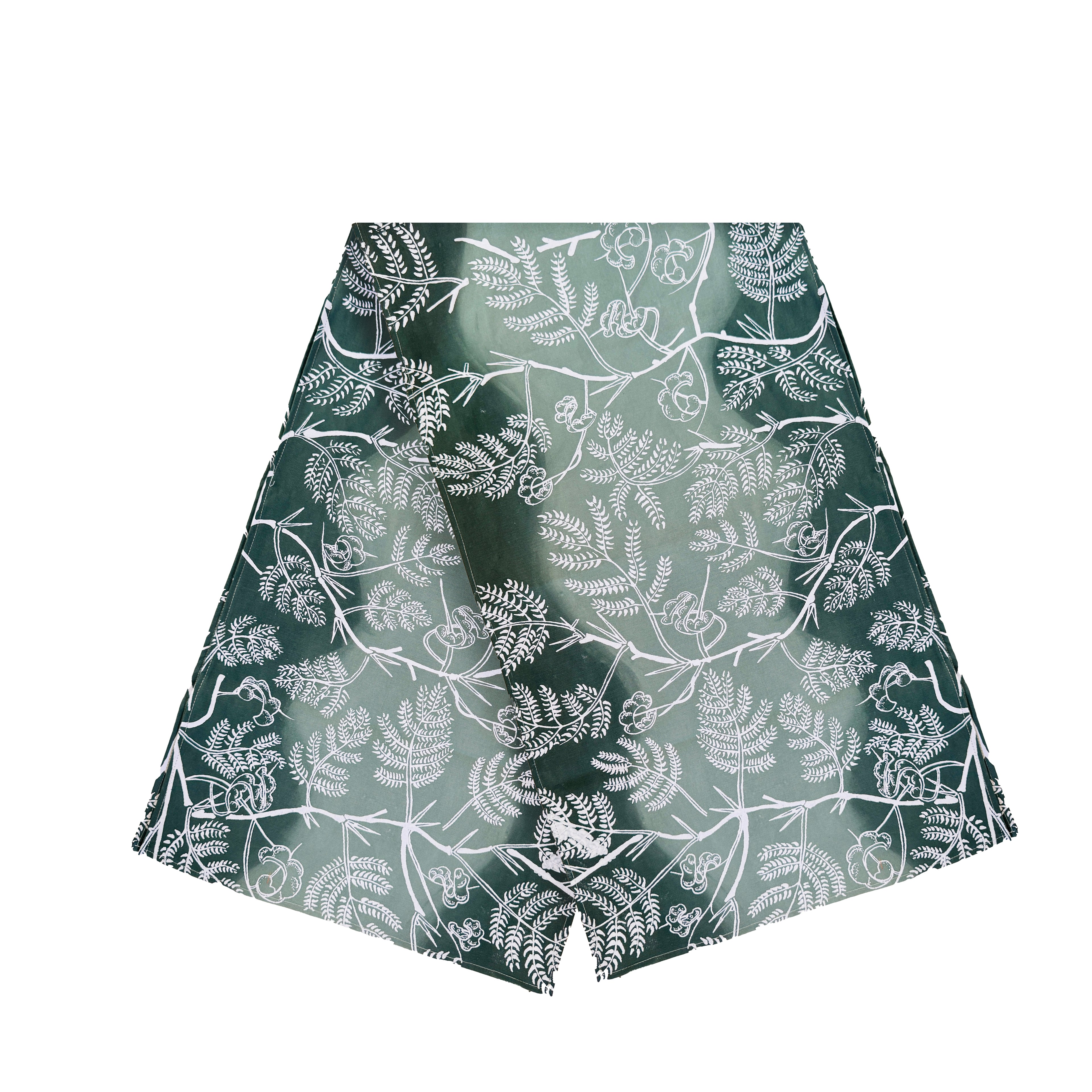 Cotton table runner with a smooth gradient from light to dark green, featuring subtle leaf patterns, handmade in Zambia for sustainable, ethical home decor and eco-conscious interiors.

