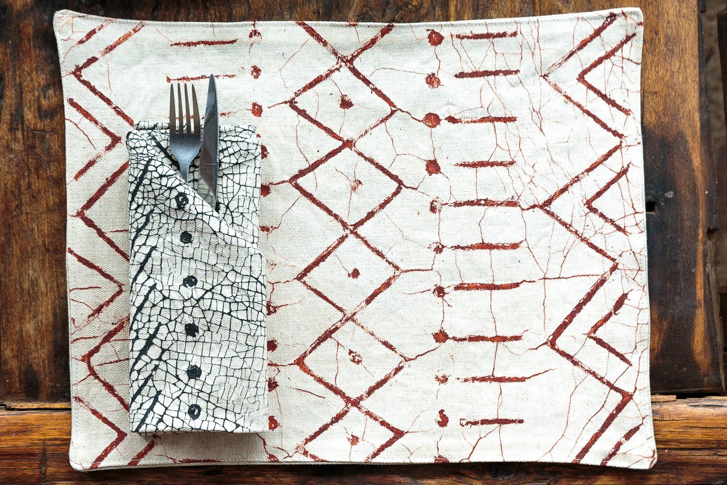 Hand-painted white table mats adorned with beautiful rust geometric patterns and made on 100% cotton.