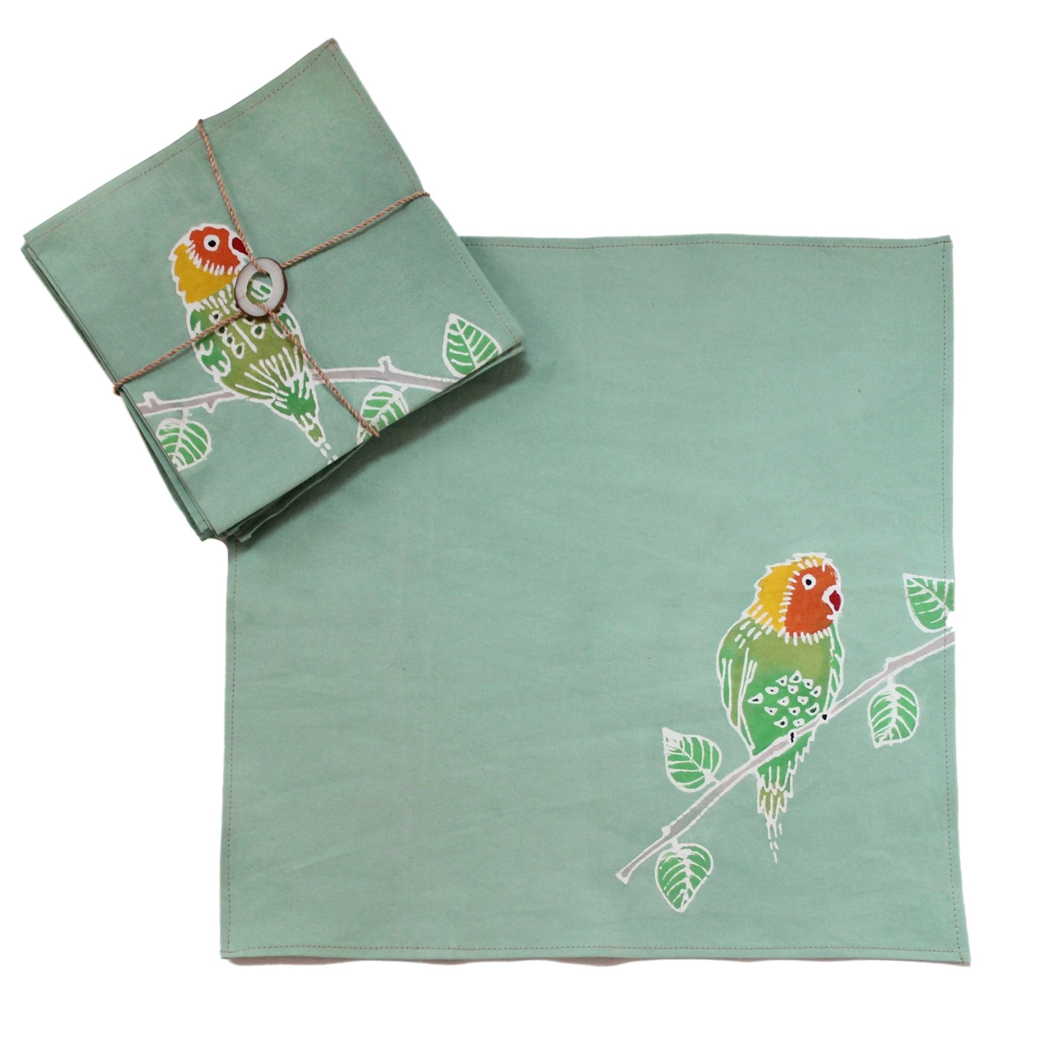 Beauitful light green napkins adorned with colourful lovebirds.