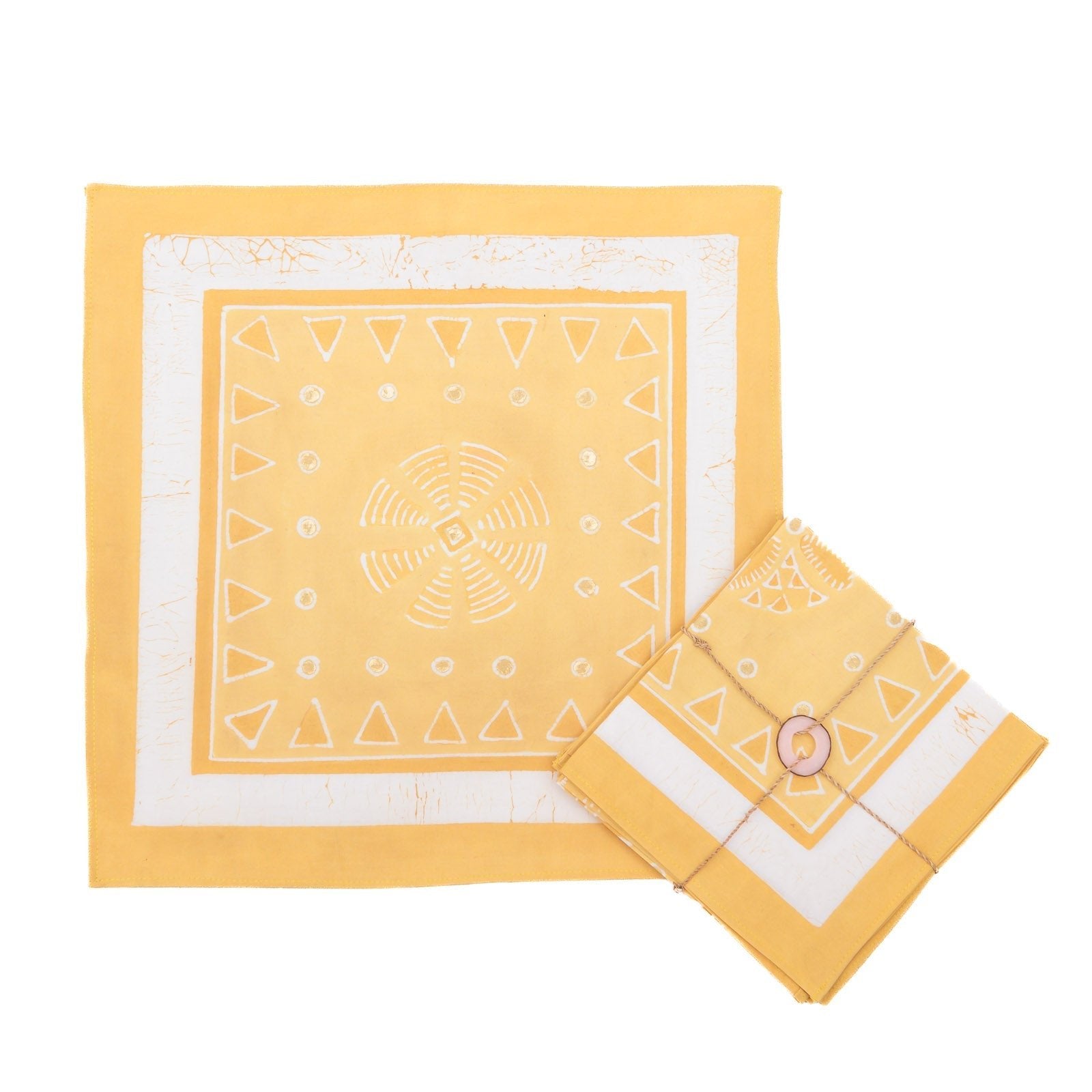 Beautiful yellow napkins, adorned with intricate circular patterns and gold accents.